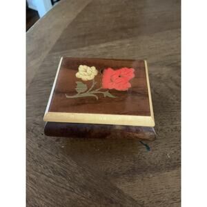 wooden music box, light brown and white wooden tones on lid with flower design